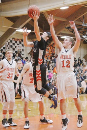 Jonesville junior Jacob Wilson drives through the lane for a layup during the first half of Friday night’s game against Quincy. Wilson was the lead scorer for the Comets with 16. ANDY BARRAND PHOTO