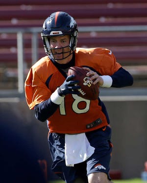 Denver Broncos quarterback Peyton Manning (18) rolls out to pass during an NFL football practice in Stanford, Calif., Thursday, Feb. 4, 2016. (AP Photo/Jeff Chiu)