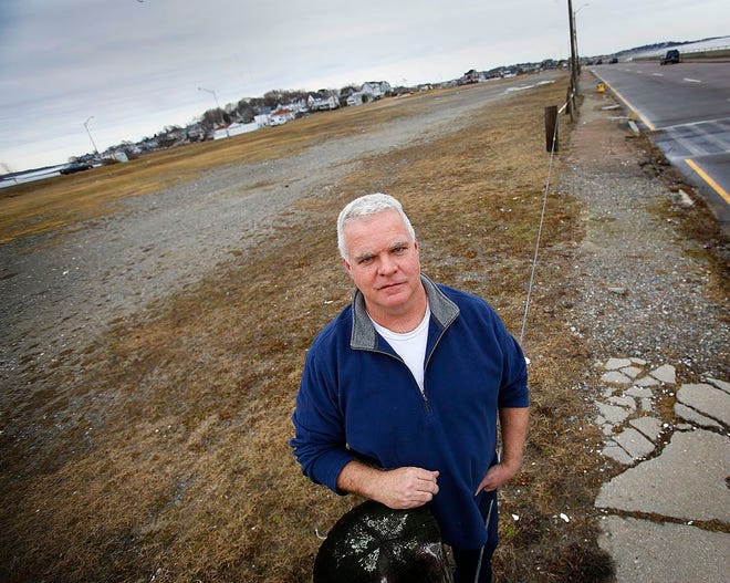 Bartley Kelly, chairman of the Hull Redevelopment Authority, stands on a vacant lot between Nantasket Avenue and Hull Shore Drive that he hopes will be developed.