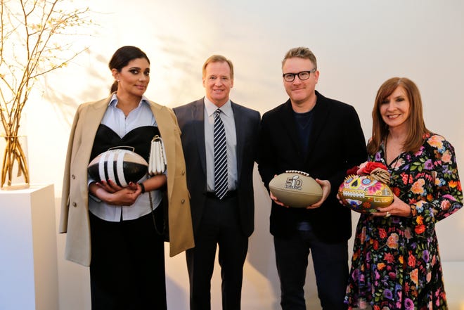 Fashion designers Rachel Roy, left, Nicole Miller, right, and Todd Snyder, second from right, pose for photographs with NFL Commissioner Roger Goodell at the unveiling of the CFDA footballs, Wednesday, Jan. 20, 2016, at NFL headquarters in New York. To mark the upcoming 50th Super Bowl, the NFL and the Council of Fashion Designers of America have collaborated on 50 designer footballs created by CFDA members. (AP Photo/Frank Franklin II)