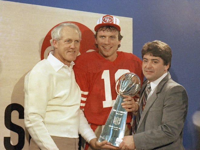 Class of 2016 Hall of Famer Edward DeBartolo Jr. (right) joins coach Bill Walsh (left) and quarterback Joe Montana in Canton. The three are pictured celebrating their Super Bowl XIX win — one of five championships the 49ers won under DeBartolo.