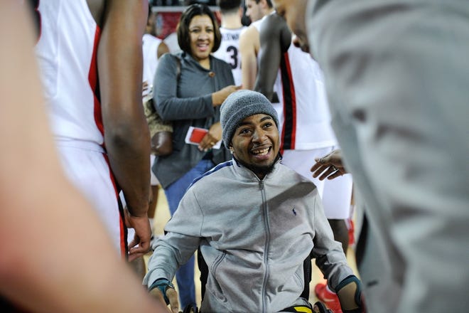 Devon Gales, center, smiles while being greeted by Georgia assistant coach Jonas Hayes during the second half of an NCAA college basketball game between Georgia and Auburn on Saturday, Feb. 6, 2016, in Athens, Ga. Georgia won 65-55. (AJ Reynolds/Staff, @ajreynoldsphoto)