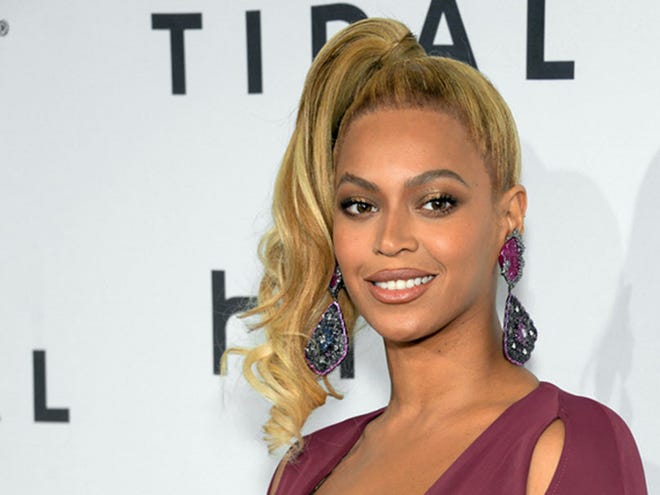 FILE - In this Oct. 20, 2015 file photo, singer Beyonce arrives at TIDAL X: 1020 Amplified by HTC at the Barclays Center in New York. A day before her performance at Sunday's Super Bowl halftime show, Beyonce has dropped a new song. Beyonce released "Formation" on Saturday, Feb. 6, 2016 as a free download on her artist page for the streaming service, Tidal, which she co-owns with husband Jay Z, Rihanna and other artists.