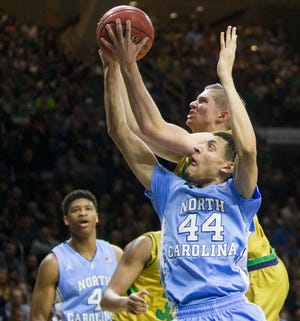 Notre Dame's Rex Pflueger (0) grabs a rebound over North Carolina's Justin Jackson (44) during the first half of Notre Dame's 80-76 win in an NCAA college basketball game Saturday, Feb. 6, 2016, in South Bend, Ind. (AP Photo/Robert Franklin)