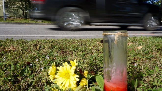 Flowers and a candle mark the scene of a hit and run that took place Dec. 20, 2014, in Boynton Beach. The incident claimed the life of Khiar Raymond, 15, as he walked along High Ridge Road with his brother and a friend on their way home after attending an event at Boynton Beach High School. (Richard Graulich / Palm Beach Post)