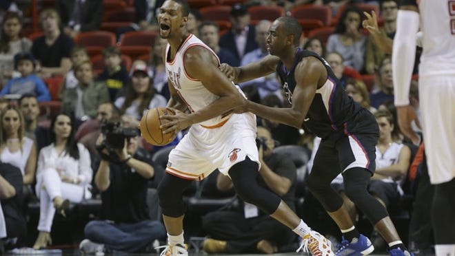 Miami Heat forward Chris Bosh, left, is defended by Los Angeles Clippers forward Luc Richard Mbah a Moute, right, during the first half of an NBA basketball game, Sunday, Feb. 7, 2016, in Miami. (AP Photo/Lynne Sladky)