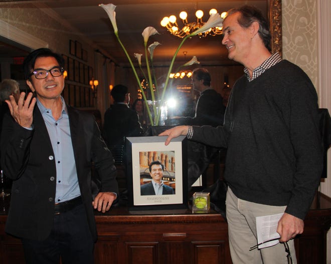 Sean Strub, right, Hotel Fauchere president and owner, welcomed Stanford Makishi of Millrift, left, to a place on the Hotel Fauchere Wall of Fame. Makishi is vice president for Programming at New York City Center. He danced for seven years with Trisha Brown Dance Company, then was hired by Mikhail Baryshnikov to be executive director of Baryshnikov Arts Center, the building of which he oversaw. As a dancer, he said, he is a man of "few words." (Jessica Cohen/For Pocono Record)