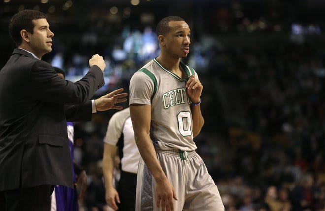 Brad Stevens, left, with Avery Bradley, insists that "no one is doing cartwheels" over the Celtics' current 9-1 stretch.