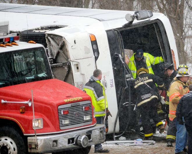 Emergency responders work at the scene of a tour bus rollover on Interstate 95 northbound in the area of exit 61 on Monday, February 8, 2016 in Madison, Conn. At least 30 people were injured, several critically, in the accident. The bus was traveling from New York City to the Mohegan Sun casino in Uncasville, Conn. (Sean D. Elliot/The Day via AP) MANDATORY CREDIT