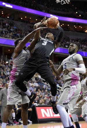 Kris Dunn (3) goes to the basket against Georgetown's Marcus Derrickson, left, and Jessie Govan (15) during PC's win on Jan. 30.