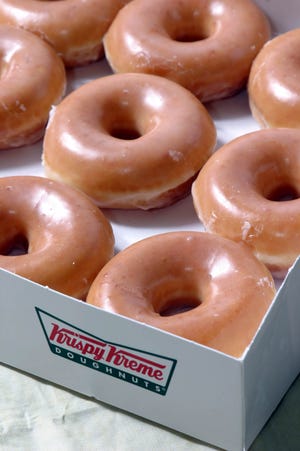 Krispy Kreme glazed doughnuts are shown. AP Photo/Nell Redmond.