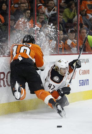 Anaheim Ducks' Hampus Lindholm (47) is knocked off the puck by Brayden Schenn of the Flyers on Tuesday, Feb. 9, 2016, in Philadelphia.