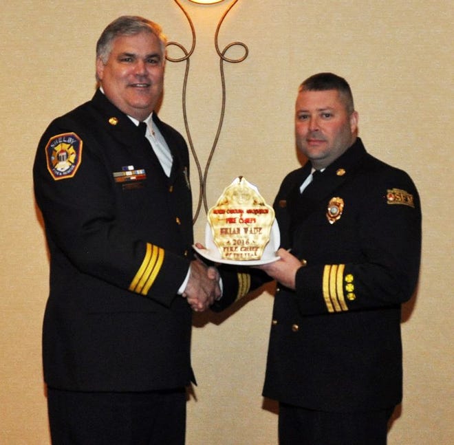 North Lenoir Volunteer Fire Department Chief Brian Wade, right, receives the award for 2016 N.C. Volunteer Fire Chief of the Year on Saturday.