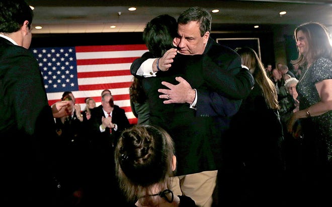 Gov. Chris Christie embraces his son Patrick during a primary night rally in Nashua, New Hampshire, on Tuesday, Feb. 9, 2016. At left is Christie's older son Andrew and wife, Mary Pat, at right. On Wednesday, the Christie campaign confirmed the Republican presidential nominee was ending his bid for the White House.