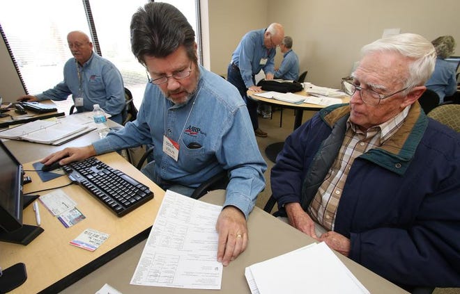 (Photo Mike Hensdill/The Gaston Gazette ) AARP and VITA volunteers are working to help people with their tax forms for free. Here, AARP volunteer Doug Joslin works with John Knipe on his taxes in a room at the Gaston Senior Center on Dallas-Cherryville Highway in Dallas Tuesday morning, February 9, 2016.