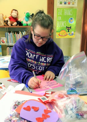 Jamie Mitchell • Times Record 
Beth Sluder makes Valentine's cards for her friends and family Tuesday, Feb 09, 2016, during a Valentine craft party at the Mulberry Library. Beth is a sixth-grade student at Mulberry Pleasant View and is the 11-year-old daughter of Von and Andy Richesin. 
 Jamie Mitchell • Times Record
Beth Sluder makes Valentine's cards for her friends and family Tuesday, Feb 09, 2016, during a Valentine craft party at the Mulberry Library. Beth is a sixth-grade student at Mulberry Pleasant View and is the 11-year-old daughter of Von and Andy Richesin.