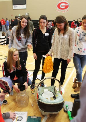 Gilbert students, from left, Lauren Burrough, Ibby Culek, Maggie Montiel and Emily Weber examine the junk items they have to create their product with during Business Horizons week at the high school. Photo by Sarina Rhinehart/Ames Tribune 
 Livvy Tyler and Drew Wilson assemble their invention they will be pitching today before a panel of investors as part of Business Horizons week at Gilbert High School. Photo by Sarina Rhinehart/Ames Tribune 
 On Tuesday, Gilbert students had to select pieces of donate junk to create products they present today before business leaders in hopes of an investment. Photo by Sarina Rhinehart/Ames Tribune 
 Gilbert students examine the junk items available to use for their invention development as part of Business Horizons week. Photo by Sarina Rhinehart/Ames Tribune 
 All juniors and seniors at Gilbert High School spent the past week developing a marketing plan, infomercial and presentation for a product they created from junk items. Photo by Sarina Rhinehart/Ames Tribune 
 Gilbert High School students work together to invent a product, which they will present today in the Tiger Tank based on the show "Shark Tank." Photo by Sarina Rhinehart/Ames Tribune 
 On Tuesday, Gilbert students had to select pieces of donate junk to create products they present today before business leaders in hopes of an investment. Photo by Sarina Rhinehart/Ames Tribune 
 Gilbert High students were separated into 14 groups this week to learn about the world of business. Photo by Sarina Rhinehart/Ames Tribune 
 The Gilbert community donated a collection of junk items used to create fake products during Gilbert High School's Business Horizons week. Photo by Sarina Rhinehart/Ames Tribune 
 Juniors and seniors at Gilbert High School spent the week participating in Business Horizons, a hands-on, unique experience for students to learn about the world of business. Photo by Sarina Rhinehart/Ames Tribune