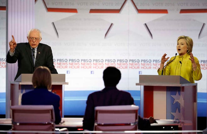 Democratic presidential candidates, Sen. Bernie Sanders, I-Vt, and Hillary Clinton argue a point during a Democratic presidential primary debate at the University of Wisconsin-Milwaukee on Thursday in Milwaukee. (AP Photo/Morry Gash)