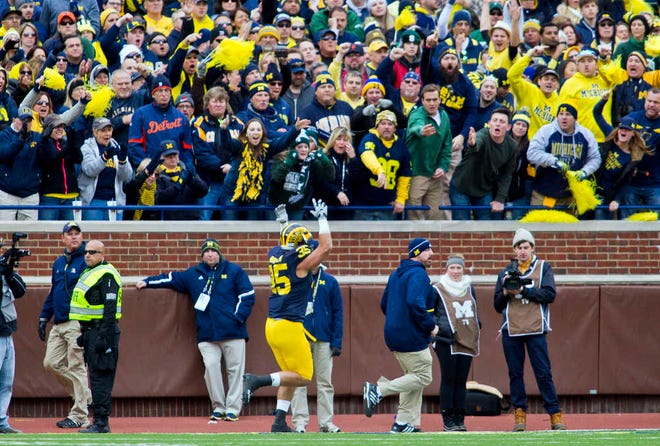 FILE - In this Oct. 17, 2015, file photo, Michigan linebacker Joe Bolden (35) gestures as he runs off the field after being ejected for a targeting penalty in the second quarter of an NCAA college football game against Michigan State, in Ann Arbor, Mich. The NCAA football rules committee has proposed giving video replay officials more authority to overturn incorrect targeting fouls and call targeting penalties when they are missed on the field. The rules committee completed four days of meetings in Orlando, Florida, on Thursday, Feb. 11, 2016, and announced several proposals that could be implemented next season if approved by the playing rules oversight panel on March 8. (AP Photo/Tony Ding, File)