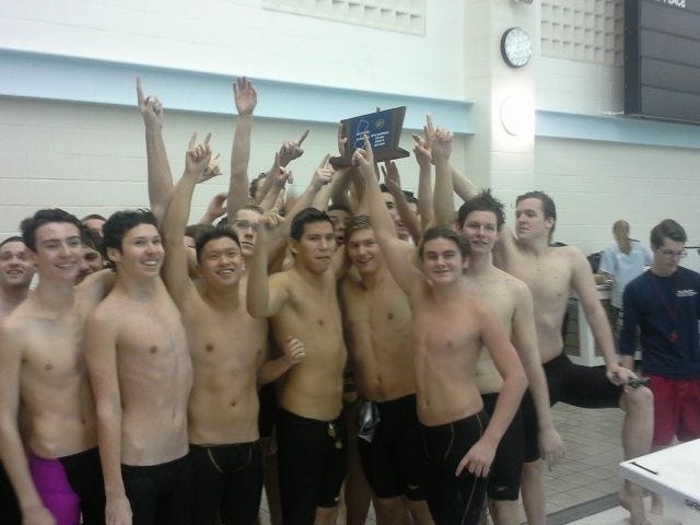 Moorestown High School's boys swimming team celebrate their fifth straight sectional title on Friday night.
