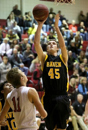 Haven's Aaron Yoder shoots over Hesston's Levi Caffery in the second quarter Friday, Feb. 12, 2016 in Hesston.