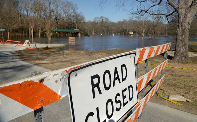 Signs serve as an alert to closed roads at Neuseway Nature Park on Thursday as the Neuse River continued to rise. The river is expected to crest at 18 feet Friday through late afternoon Saturday.