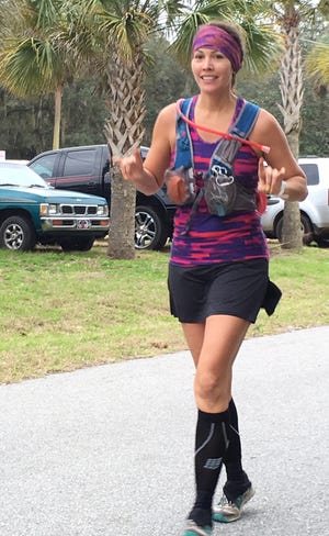 This photo shows ultra-marathon runner Marjesca Brown as she completes one loop down and has three more to go.