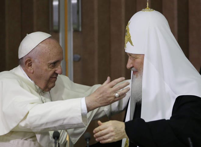 Pope Francis, left, reaches to embrace Russian Orthodox Patriarch Kirill on Saturday after signing a joint declaration in Havana. The pope stopped in Cuba en route to a five-day visit to Mexico