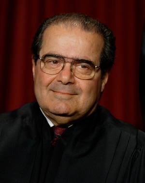In this Monday, Oct. 31, 2005 file photo, Associate Justice Antonin Scalia joins the members of the Supreme Court for photos during a group portrait session, at the Supreme Court Building in Washington. On Saturday, Feb. 13, 2016, the U.S. Marshals Service confirmed that Scalia has died at the age of 79. (AP Photo/J. Scott Applewhite)
