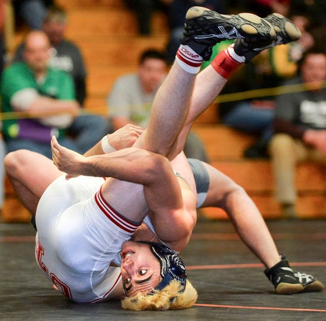 Dylan Thurston of Washington balances on his head and tries to turn opponent Micah Krueger of Ottawa during their 132 lb. championship match during the Class 2A Washington Sectional. Thurston won the match 5-3.