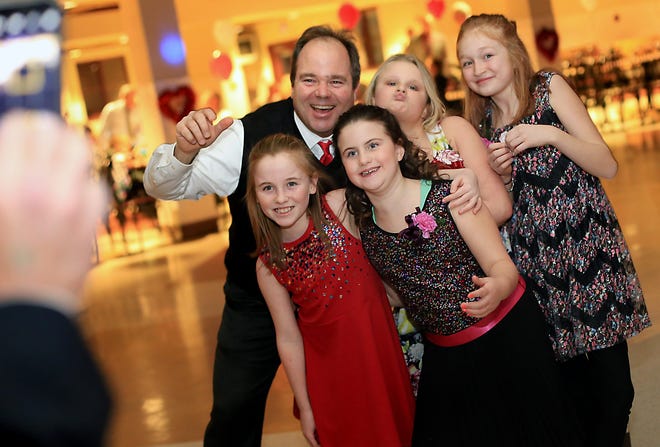 Portsmouth Recreation Department Supervisor Tom Kozikowski poses for a photo with his daughter and her friends at the annual Father-Daughter Valentine Dance. The girls pictured, back row from left, Elise Gravelle, Gabriella Karkos, front row from left, Stella Kozikowski, and Laci Guerra.

Ioanna Raptis/Seacoastonline