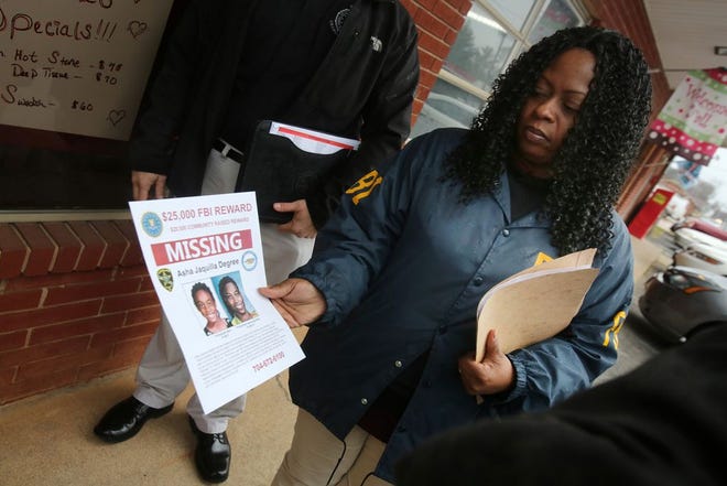 FBI officers hand out flyers with a updated rendering of Asha Degree. The Cleveland County Sheriff's Department announced a partnership with the FBI in February of 2015 to raise the reward money for information in the Asha Degree case. (Star file photo)