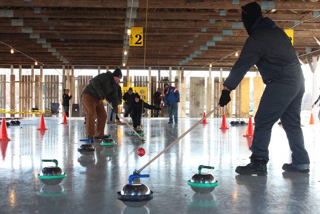 Steve Yewchuck, left, sweeps for the Reese Aircraft Flyers during the Wallkill Lions Club's Annual International Curling Tournament on Saturday at Popps Pavilion in the hamlet of Wallkill. AMANDA LOVIZA-VICKERY/TIMES HERALD-RECORD