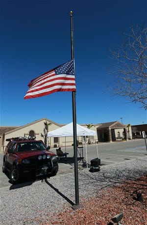 The U.S. flag flies at half-staff outside the Sunset Funeral Home, Sunday Feb. 14, 2016 in El Paso, Texas. Antonin Scalia's body lay in a Texas funeral home Sunday and officials waited word about whether they would need to perform an autopsy before the late Supreme Court justice could return home to Virginia. In Washington, where flags flew at half-staff at the White House and Supreme Court, the political sniping soared, raising the prospect of the court remaining short-handed for some time. (VIctor Calzada/The El Paso Times via AP)