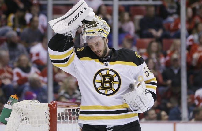 Bruins goalie Jonas Gustavsson (50) puts on his helmet during the second period of Sunday's 6-5 loss to the Red Wings. Gustavsson was summoned after Tuukka Rask allowed five goals.