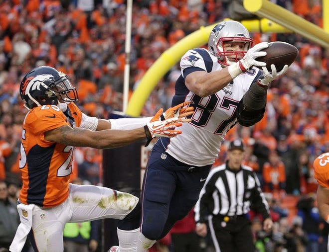 Patriots tight end Rob Gronkowski catches a touchdown pass while being defended by Broncos cornerback Chris Harris in the AFC Championship Game in Denver. He ended his All-Pro season with 72 receptions for 1,176 yards and 11 touchdowns.