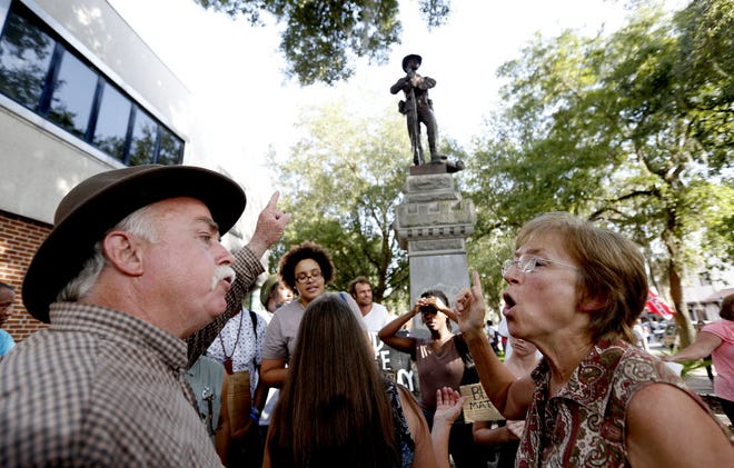 Protesters for and against the removal of the Confederate statue outside the Alachua County Administration building argue in July.