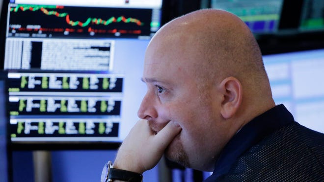 A stock trader works at the New York Stock Exchange, Thursday, Feb. 11, 2016, in New York. (AP Photo/Mark Lennihan)