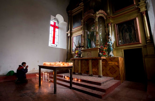 In this Jan. 17, 2016 photo, a Tzotzil man prays before an altar at the Church of San Pedro in Chenalho, in the Mexican state of Chiapas. The Mexican hierarchy has long bristled at the region's "Indian church," a mixture of Catholicism and indigenous culture that includes pine boughs, eggs and references to "God the Father and Mother" in services. (AP Photo/Eduardo Verdugo)