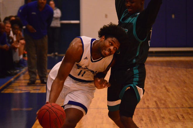 Deltona's Evan Hinson drives past Atlantic's DeAndre Harvey during a game earlier this season. Hinson and the Wolves meet the Sharks Tuesday in the Class 6A playoffs. Deltona won the first meeting between the teams this season, but Atlantic won the last two. News-Journal/BRIAN LINDER