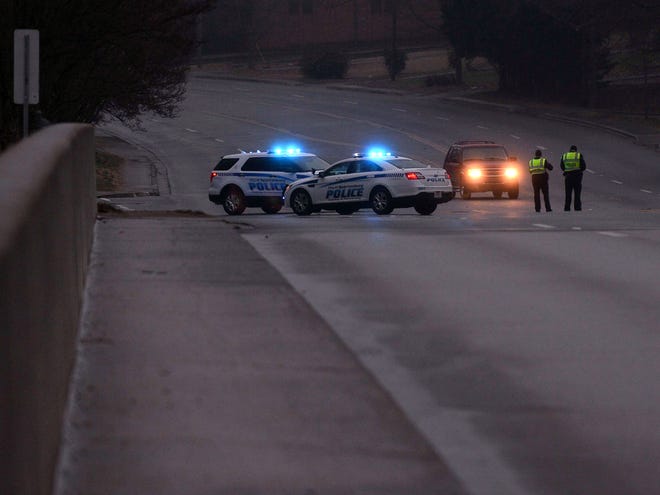 Spartanburg Police officers block a bridge from traffic after ice began accumulating on the bridge on Drayton Road in Spartanburg, Monday evening, February 15, 2016. Icy conditions were all over the Upstate, causing many accidents.
