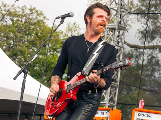 FILE - In this Sept. 11, 2015 file photo, Jesse Hughes of Eagles of Death Metal performs at Riot Fest & Carnival in Douglas Park in Chicago. Hughes, frontman of the U.S. band whose Nov. 13 performance at the Bataclan theater in Paris was stormed by Islamic extremist suicide bombers, says he feels a "sacred" responsibility to finish the show and is happy to be back in Paris despite raw nerves. The Eagles of Death Metal band is scheduled to play at the Olympia Theatre in Paris on Tuesday, Feb. 16, 2016 - just a little over three months to the day since the Paris attacks that killed 89 people.