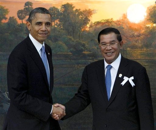 FILE - In this Nov. 19, 2012 file photo, President Barack Obama shakes hands with Cambodia's Prime Minister Hun Sen in Phnom Penh, Cambodia. When President Barack Obama welcomes Southeast Asian leaders for a shirt-sleeves summit in California this week, he'll have some interesting dining companions. There will be a coup leader with a penchant for song, a sultan with a taste for the high life and a ruthless prime minister with 31 years on the job. (AP Photo/Vincent Thian, File)