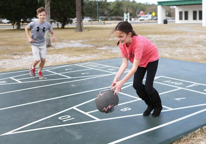 Olivia Fitzgerald plays four-square with Drew Bailey and other Hutchison Beach Elementary students Monday at Frank Brown Park in Panama City Beach. Bay District School students, as well as the federal government, banks and a few businesses, were closed Monday for Presidents Day, but a group from Hutchison got together nonetheless.