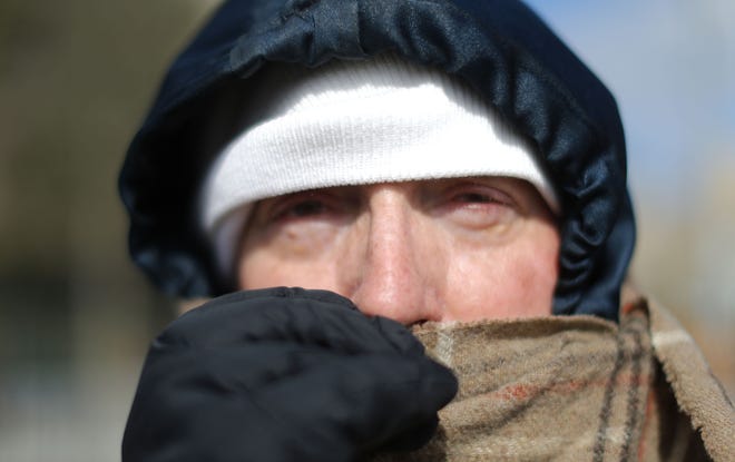 File photo - Jay Benedetti, from Atlanta, bundles up for the cold while attending a "prayer rally" led by Evangelist Rev. Franklin Graham at Liberty Plaza near the state Capitol, in Atlanta, Wednesday, Feb. 10, 2016. (Bob Andres/Atlanta Journal-Constitution via AP)