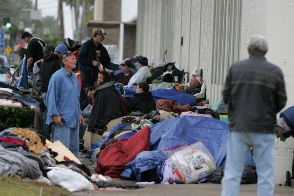 Homeless people camp outside the Volusia County Administration Building earlier this month, before the camp was broken up.