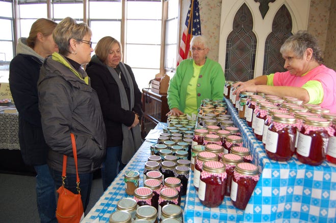 Jo Miller tells about her jams and jellies during the Body and Soul event in Jonesville Saturday. NANCY HASTINGS PHOTO