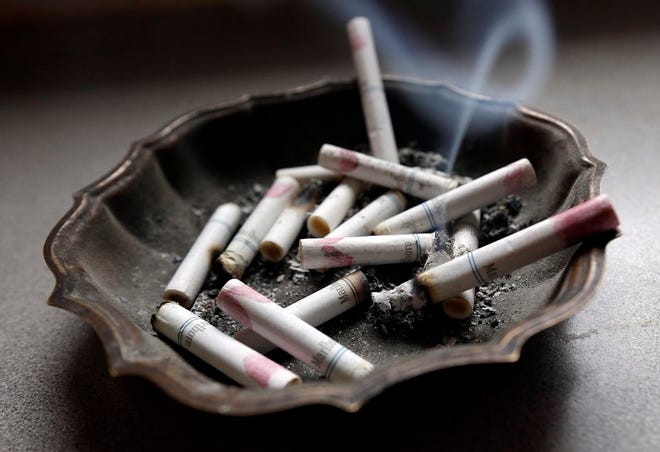 In this Saturday, March 2, 2013, photo, a cigarette burns in an ashtray at a home in Hayneville, Ala.
