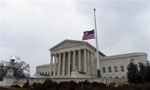 The flag flies at half-staff outside the Supreme Court in Washington on Tuesday, Feb. 16, 2016, following the death of Supreme Court Justice Antonin Scalia over the weekend.