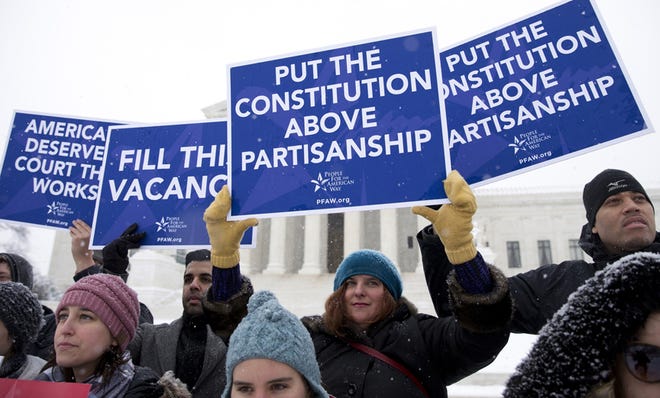 A group with "People for the American Way" from Washington, gather with signs in front of the U.S. Supreme Court in Washington, Monday, Feb. 15, 2016, as they are call for Congress to give fair consideration to any nomination put forth by President Barack Obama to fill the seat of Antonin Scalia. (AP Photo/Carolyn Kaster)